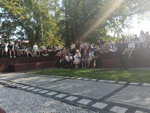 Zebrana młodzież szkolna i podopieczni Środowiskowego Domu Samopomocy na skwerze podczas Narodowego Czytania