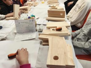 Dzieci na warsztatach wykonują budki lęgowe dla ptaków